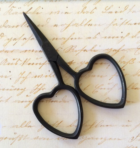 A pair of professional-grade miniature embroidery scissors featuring iconic heart-shaped handles in matt coloured