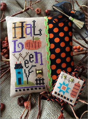 Close-up of the "Halloweenie" cross stitch design, showcasing the signature Lizzie*Kate primitive folk-art style with whimsical pumpkins, spooky motifs, and a warm autumnal color palette