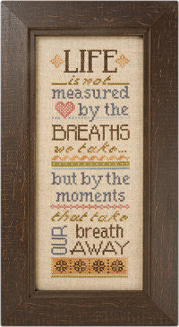 A professional Lizzie*Kate cross-stitch chart featuring the inspirational quote: 'Life is not measured by the breaths we take, but by the moments that take our breath away.' The high-definition design is presented in a vertical sampler style, using a variety of whimsical and elegant fonts.