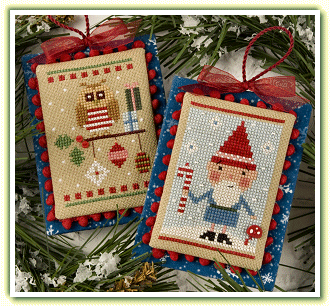 The Lizzie*Kate 'Snow Dudes' cross-stitch kit featuring two designs: a Santa gnome with a mushroom button and a holiday owl with iridescent beads

Two finished Snow Dudes ornaments displayed on a Christmas tree, showing the Santa gnome and owl with their 3D button and bead accents.