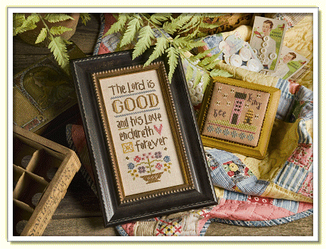 A professional Lizzie*Kate 'Boxer Kit' featuring the inspirational design 'The Lord is Good.' The high-definition sampler features a colorful, classic aesthetic with stylized floral motifs surrounding the Psalm 100:5 verse. The kit is a complete boutique package containing 30-count natural linen, a set of decorative embellishments, full skeins of DMC embroidery floss, a needle, and the primary stitching chart. A bonus 'Bee Kind' chart is also included for an extra 'bitesize' project
