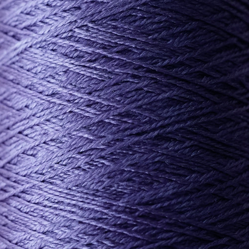 The iridescent effect of Pierrot Silk100 yarn, showing how the color changes from deep jewel tones to bright highlights under different lighting in wisteria purple colour