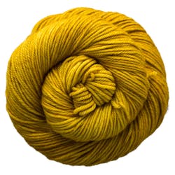 Malabrigo Caprino yarn in Frank Ochre, a soft blend of 80% Super Fine Merino and 20% Cashmere, hand-dyed texture.