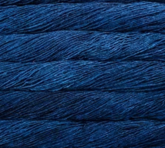 A 50g skein of Malabrigo Silky Merino yarn, featuring a premium 50% silk and 50% merino wool blend in a dk weight for a soft, shimmering finish in Blue