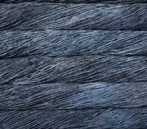 A 50g skein of Malabrigo Silky Merino yarn, featuring a premium 50% silk and 50% merino wool blend in a dk weight for a soft, shimmering finish in Cirrus Gray