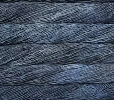 A 50g skein of Malabrigo Silky Merino yarn, featuring a premium 50% silk and 50% merino wool blend in a dk weight for a soft, shimmering finish in Cirrus Gray