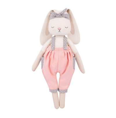 Stuffed toy rabbit with pink overalls and a polka dot bow, complete with a sewing pattern and materials as part of a sewing kit.