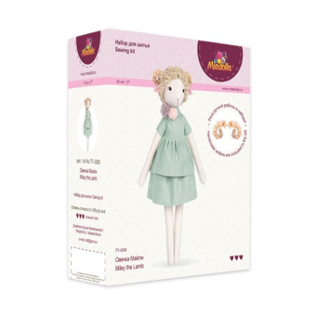 A premium doll-sewing kit by Miadolla featuring 'Miley the Lamb.' The kit includes high-quality linen and fabrics for the body and her baker-style outfit, mouline cotton threads for facial details, a sewing needle, and polyester stuffing. The finished lamb stands 43cm tall and features a gentle, artistic design inspired by a love for baking and dessert