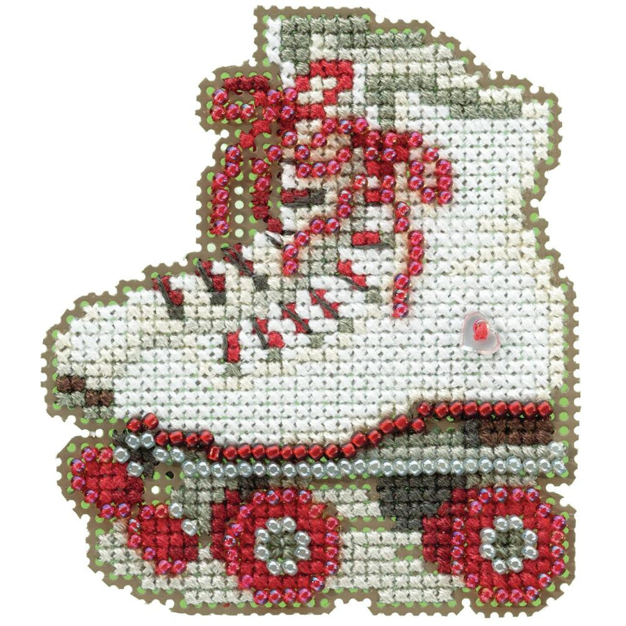 A cross stitch kit depicting a pair of roller skates with red and silver beads, completed needlework presented.