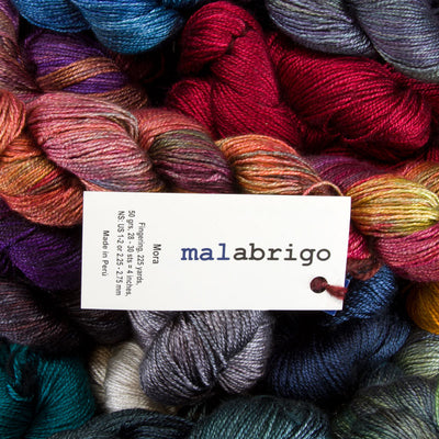 A collection of Malabrigo Mora yarn skeins in various colors.