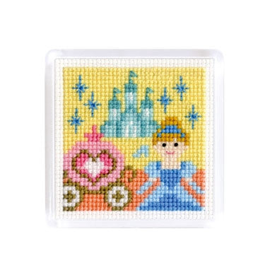 A cross stitch magnet featuring fairy tale characters Cinderella, carriage and  castle at the back ground