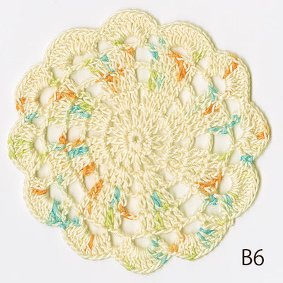 A spool of Olympus Grande (Baby) Cotton thread in a soft pastel shade. The image shows the smooth, matte texture of the 100% cotton yarn, highlighting its high-quality twist and premium Japanese packaging, perfect for baby garments and delicate fiber arts."