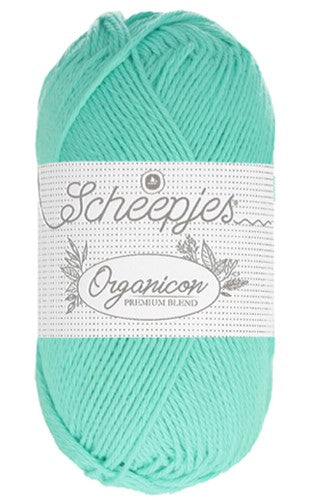 A 50g ball of Scheepjes Organicon yarn in a soft pastel shade, showcasing its smooth matte finish and 100% organic cotton texture in mint color.