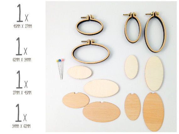 Close-up of the Dandelyne oval kit components: precision wooden frames, backing plates, and small bolts for securing miniature fabric art

Packaging of Dandelyne Oval Mini Hoop (set of 4) with miniature hoops displayed in a clear window, accompanied by small decorative items like screws, bolts, backing pieces, and center plates.