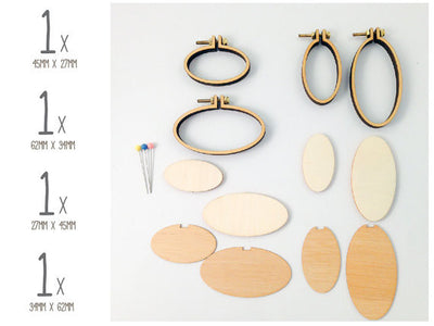 Close-up of the Dandelyne oval kit components: precision wooden frames, backing plates, and small bolts for securing miniature fabric art

Packaging of Dandelyne Oval Mini Hoop (set of 4) with miniature hoops displayed in a clear window, accompanied by small decorative items like screws, bolts, backing pieces, and center plates.