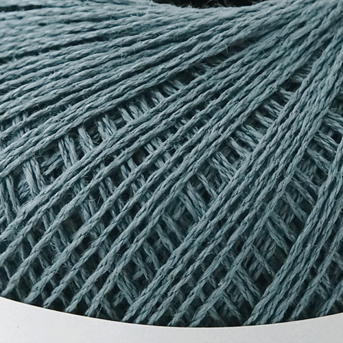 A 40g ball of Pierrot Chanvre, a 100% linen yarn made in Japan, showing its smooth, natural fiber texture and slight lustrous sheen in antique blue
