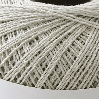 A 40g ball of Pierrot Chanvre, a 100% linen yarn made in Japan, showing its smooth, natural fiber texture and slight lustrous sheen in mist grey