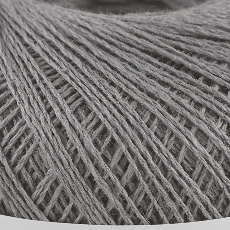 A 40g ball of Pierrot Chanvre, a 100% linen yarn made in Japan, showing its smooth, natural fiber texture and slight lustrous sheen in slate grey