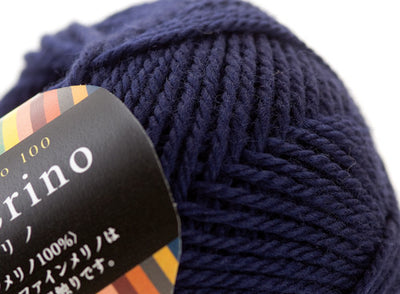 Close-up of premium Japanese Pierrot Fine Merino wool, showcasing the smooth, anti-pilling texture and fine weight suitable for intricate knitting deep navy
