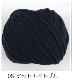 A 40g ball of Pierrot La Provence yarn, featuring 100% French Merino wool made in Japan with a soft, plump, multi-ply twist in dark Navy
