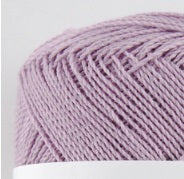 A compact ball of New Shine Cotton by Pierrot, highlighting the way light reflects off the polished cotton strands, characteristic of high-quality Japanese yarn in Lilac Colour.