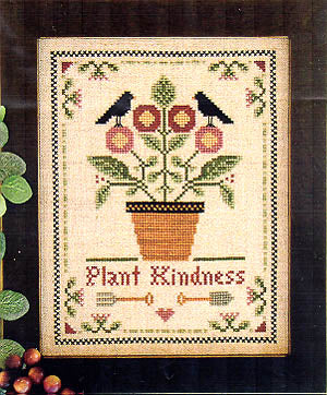 A cross stitch chart for a plant kindness design, depicting a plant in a brown pot with a green and pink color scheme, and the text 'PLANT KINDNESS' at the bottom.