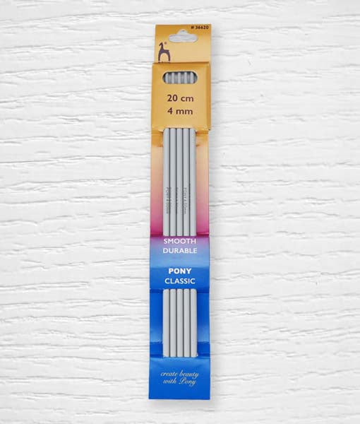 A set of four Pony double pointed knitting needles in a classic grey finish. The image highlights the softly rounded tips and the smooth surface of the aluminum/plastic material, designed for seamless circular knitting. The needle size is clearly printed on each individual needle for easy identification