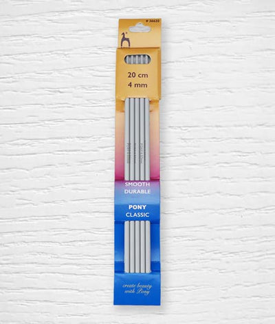 A set of four Pony double pointed knitting needles in a classic grey finish. The image highlights the softly rounded tips and the smooth surface of the aluminum/plastic material, designed for seamless circular knitting. The needle size is clearly printed on each individual needle for easy identification