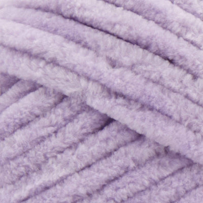 A plush skein of Premier Parfait Chunky chenille yarn in Lilac showcasing its thick, velvety texture. The image highlights the super bulky #6 weight and the vibrant matte finish of the polyester fibers, ideal for creating soft toys, cozy blankets, and kid-friendly crochet projects