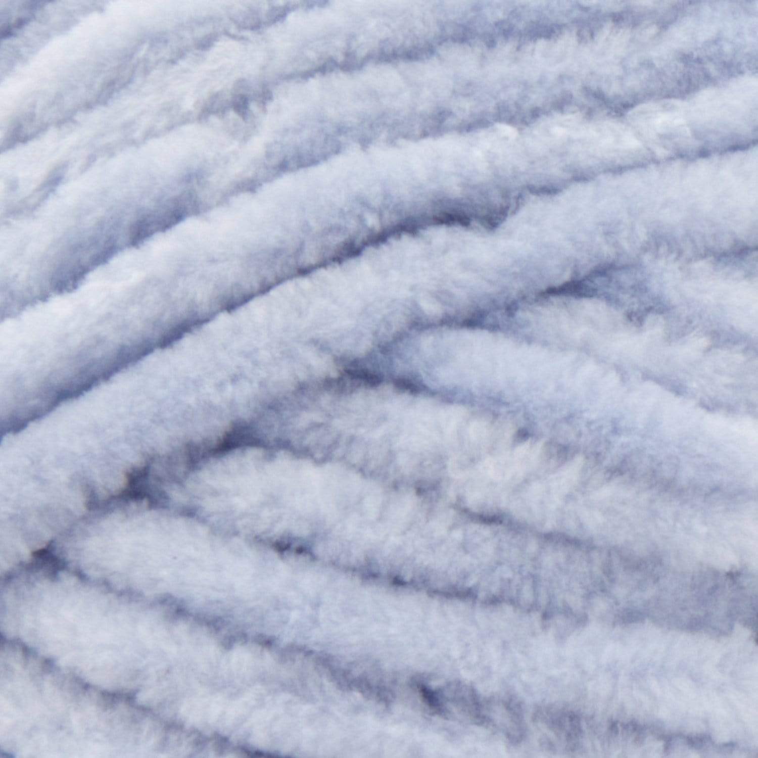 A fluffy skein of Premier Parfait Chunky yarn with a slight sheen, demonstrating its thick, rounded strand in pale blue colour