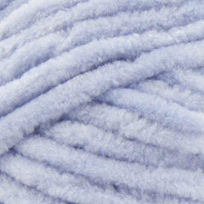 A fluffy skein of Premier Parfait Chunky yarn with a slight sheen, demonstrating its thick, rounded strand in pale blue colour