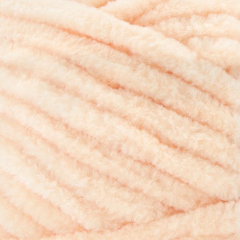 A plush skein of Premier Parfait Chunky chenille yarn showcasing its thick, velvety texture. The image highlights the super bulky #6 weight and the vibrant matte finish of the polyester fibers, ideal for creating soft toys, cozy blankets, and kid-friendly crochet projects in peach colour