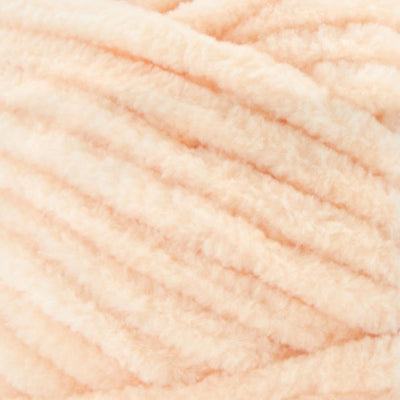A plush skein of Premier Parfait Chunky chenille yarn showcasing its thick, velvety texture. The image highlights the super bulky #6 weight and the vibrant matte finish of the polyester fibers, ideal for creating soft toys, cozy blankets, and kid-friendly crochet projects in peach colour