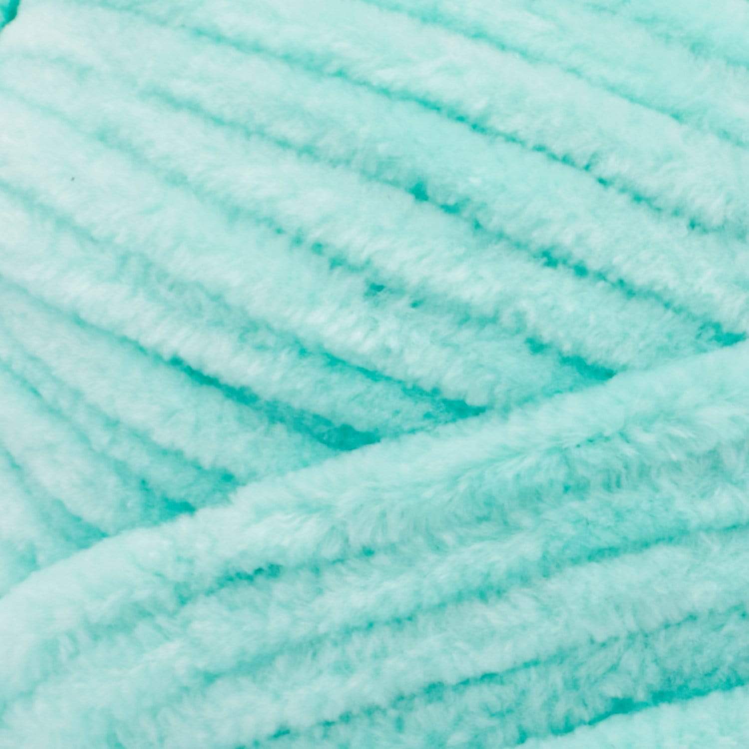Close-up of Premier Parfait Chunky polyester yarn, highlighting the dense, plush pile and vibrant color in sea glass green colour