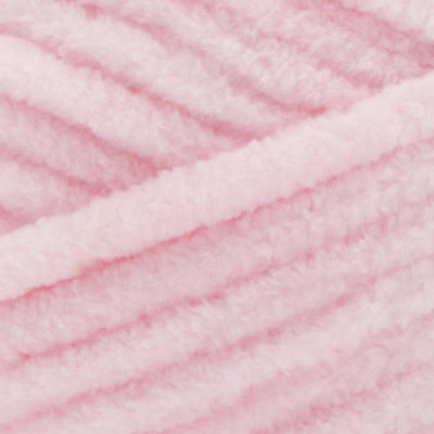Close-up of Premier Parfait Chunky polyester yarn, highlighting the dense, plush pile and vibrant color in cotton candy pink colour