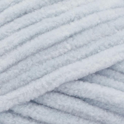 A plush skein of Premier Parfait Chunky chenille yarn showcasing its thick, velvety texture. The image highlights the super bulky #6 weight and the vibrant matte finish of the polyester fibers, ideal for creating soft toys, cozy blankets, and kid-friendly crochet projects in pale grey colour