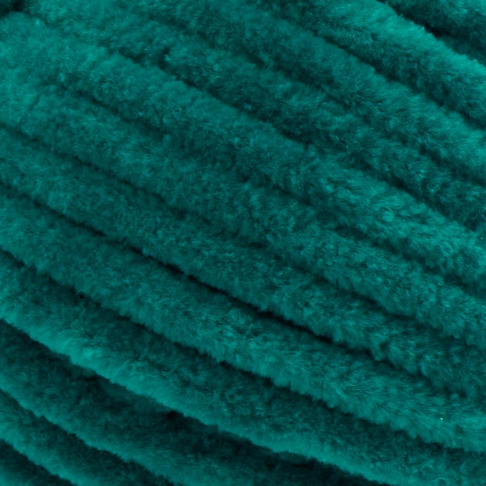 Close-up of Premier Parfait Chunky polyester yarn, highlighting the dense, plush pile and vibrant color in emerald green colour
