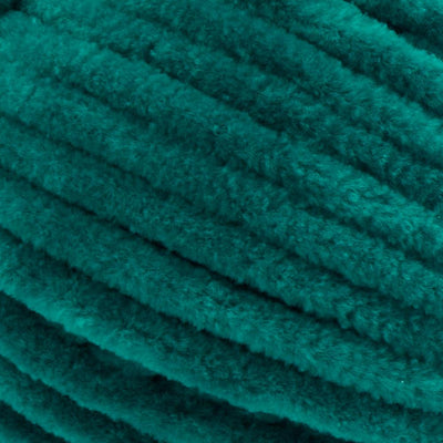 Close-up of Premier Parfait Chunky polyester yarn, highlighting the dense, plush pile and vibrant color in emerald green colour