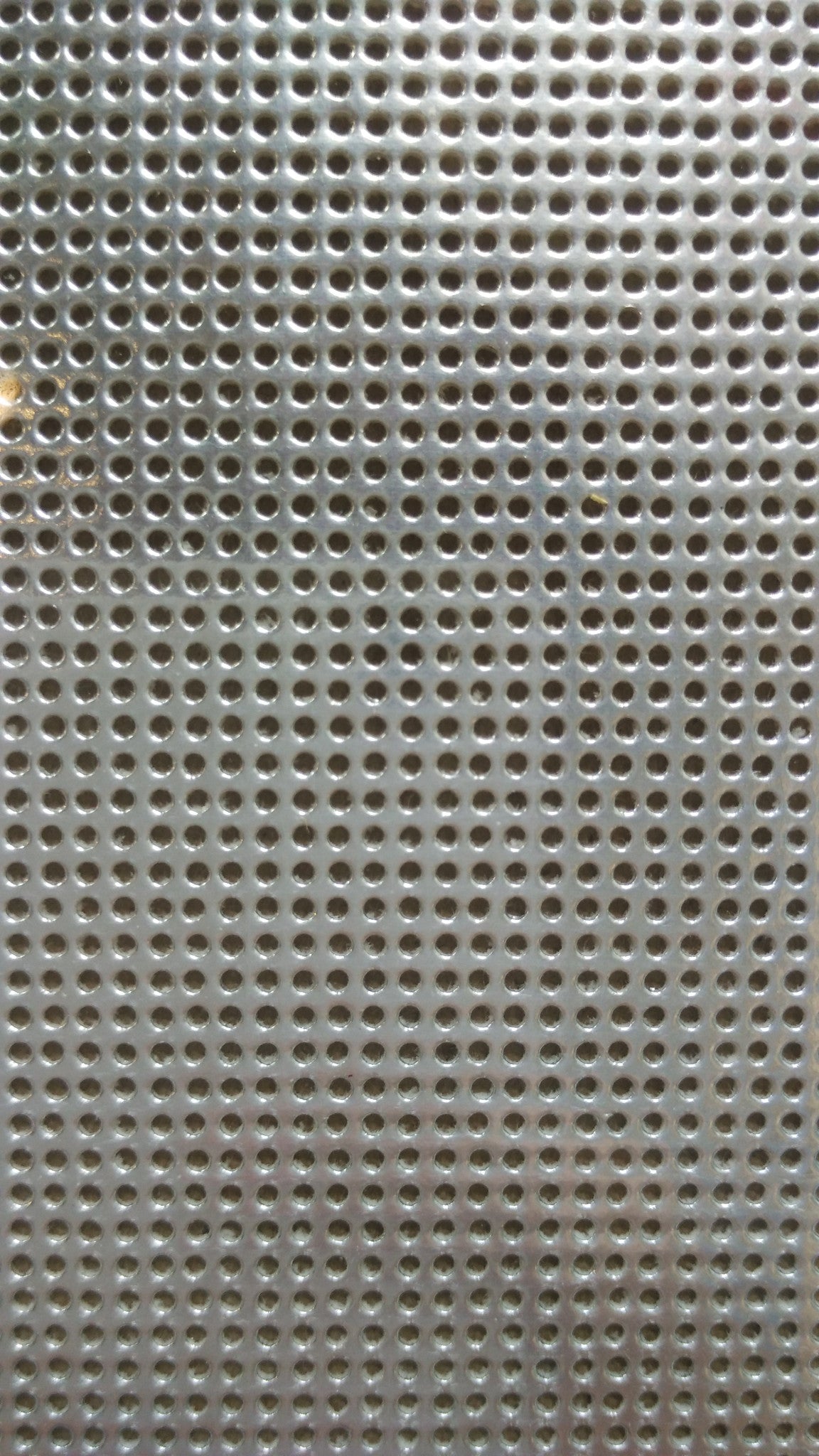 A professional-grade sheet of 14-count perforated paper, specifically designed for cross-stitch and needlework. The high-definition paper features precision-punched holes at 14 stitches per inch, mimicking the grid of Aida cloth but with a firm, card-like structure available in Metallic Silver