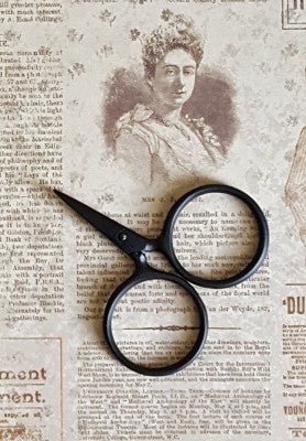 A pair of Putford Primitive miniature scissors featuring distinctively large circular finger holes and short, sharp blades. The scissors are shown in three vintage-inspired colors, highlighting their compact 2.5-inch size and handcrafted 'primitive' aesthetic, perfect for precise thread snipping