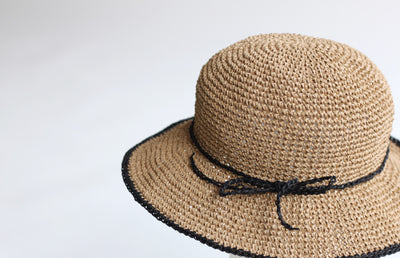 A stylish, wide-brimmed summer hat crocheted with Sasawashi Flat, showing the crisp stitch definition and the yarn's ability to hold its shape