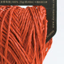 A donut of Daruma Sasawashi Flat yarn, showing its sleek, ribbon-like structure and the natural, soft-gold luster of Kumasasa bamboo paper in bright orange