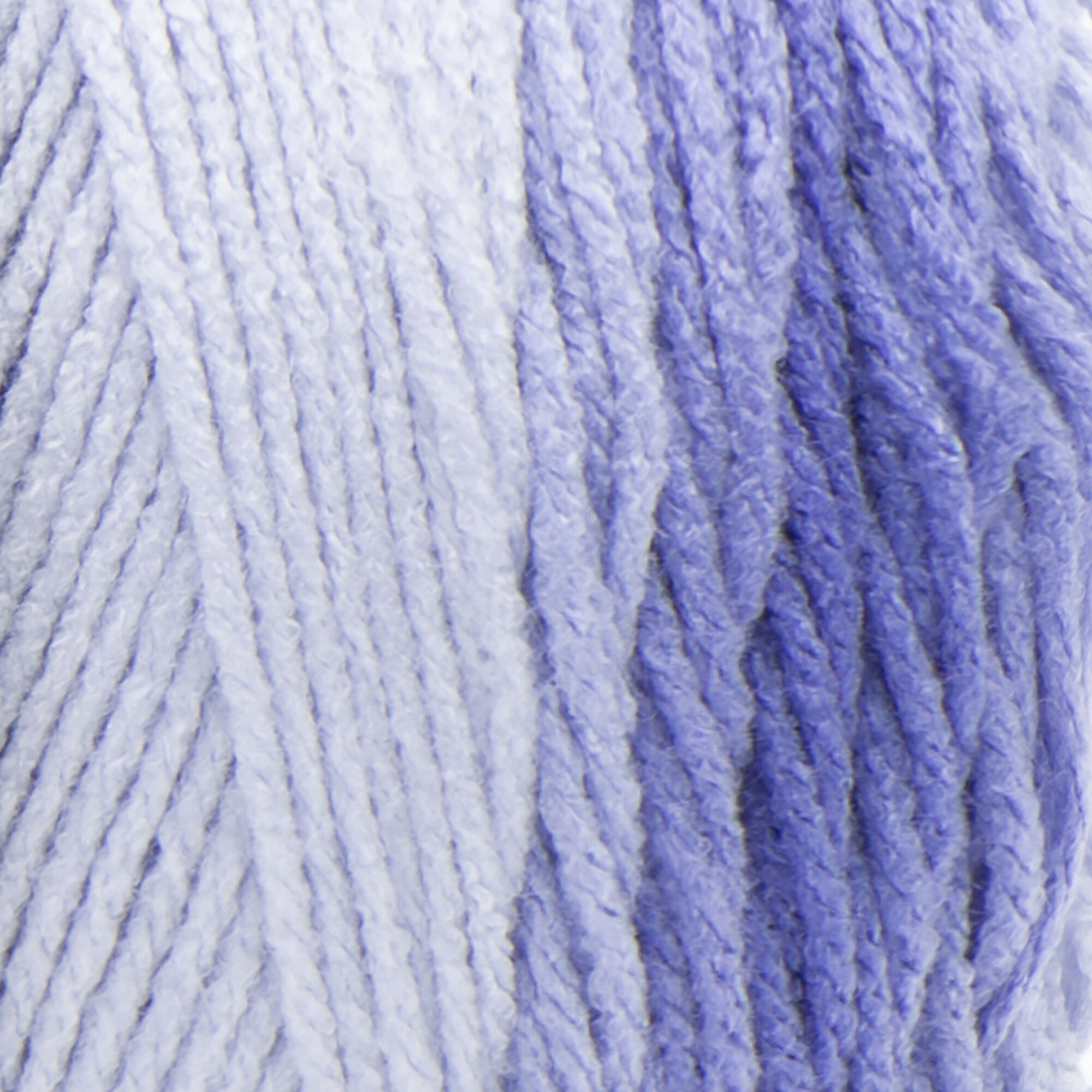 A large 283-gram skein of Red Heart Super Saver Ombre yarn, showing a beautiful gradient transition from a light tint to a deep, saturated shade Blue color. The yarn has a classic 4-ply twist and a soft matte finish, perfect for creating shawls, blankets, and garments with a natural ombré effect