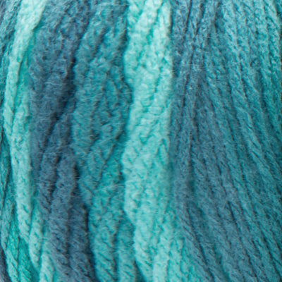 A large 283-gram skein of Red Heart Super Saver Ombre yarn, showing a beautiful gradient transition from a light tint to a deep, saturated shade Green to Teal color. The yarn has a classic 4-ply twist and a soft matte finish, perfect for creating shawls, blankets, and garments with a natural ombré effect
