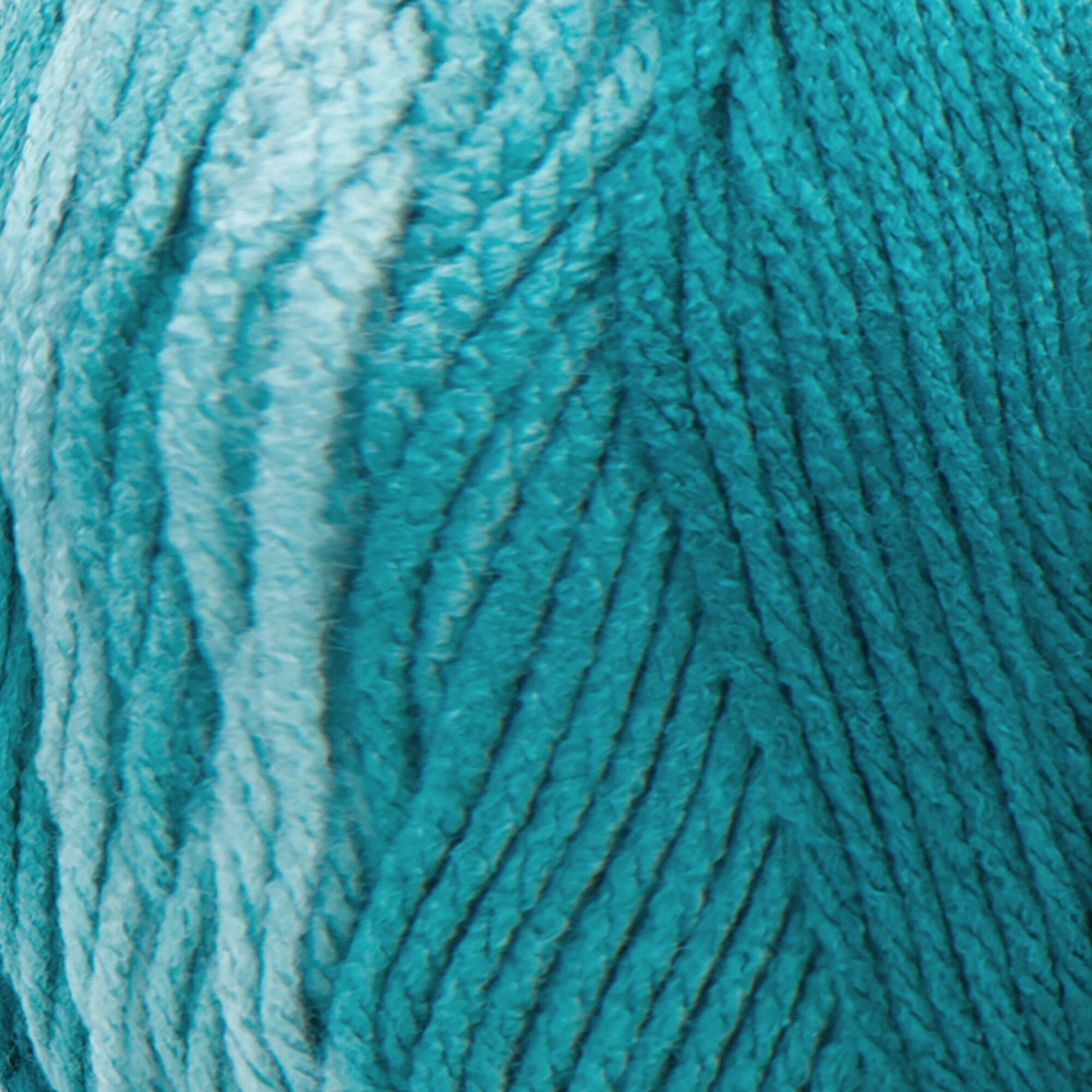A large 283-gram skein of Red Heart Super Saver Ombre yarn, showing a beautiful gradient transition from a light tint to a deep, saturated shade of teal color. The yarn has a classic 4-ply twist and a soft matte finish, perfect for creating shawls, blankets, and garments with a natural ombré effect