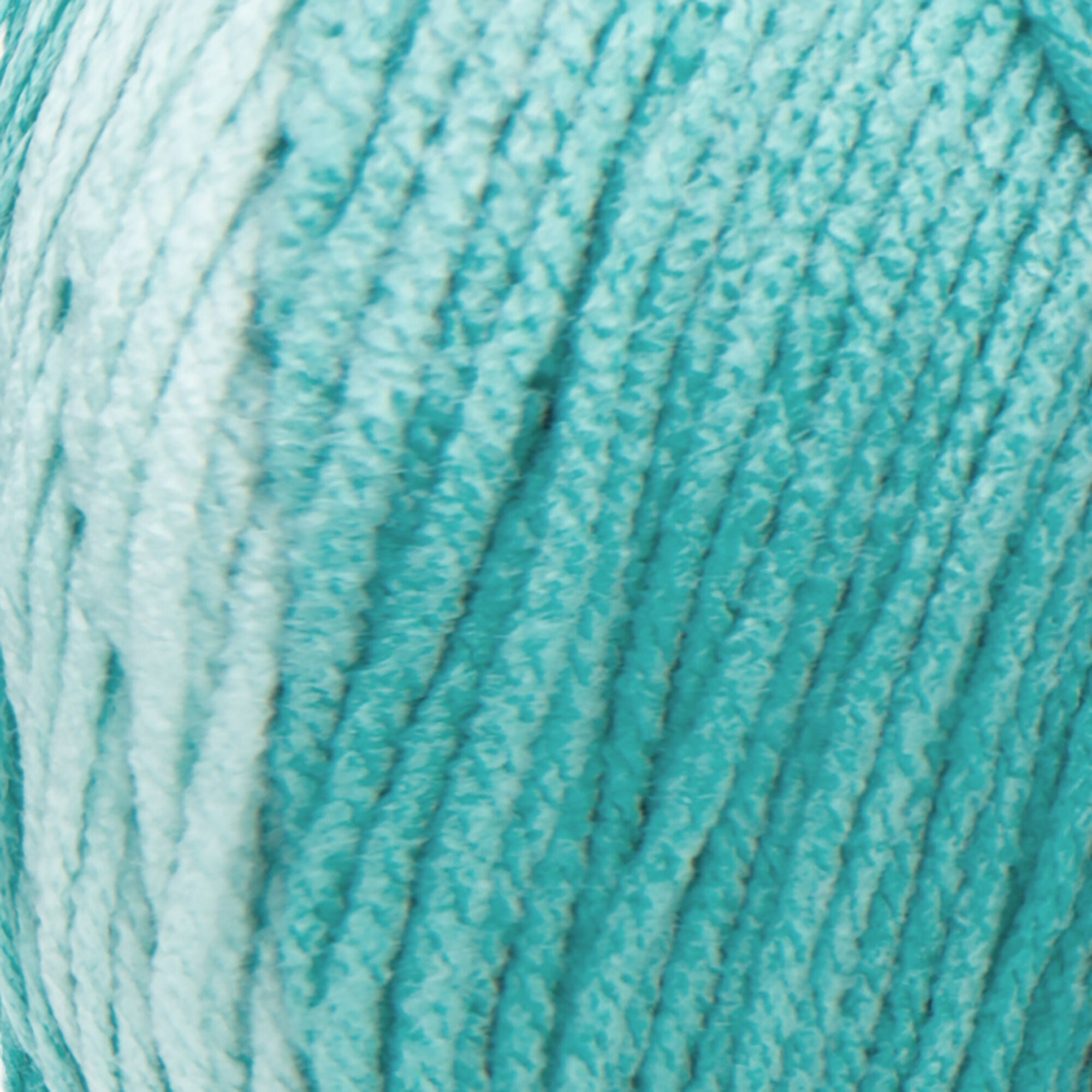 A large 283-gram skein of Red Heart Super Saver Ombre yarn, showing a beautiful gradient transition from a light tint to a deep, saturated shade in spearmint color. The yarn has a classic 4-ply twist and a soft matte finish, perfect for creating shawls, blankets, and garments with a natural ombré effect