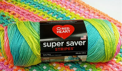 Red Heart Super Saver worsted weight yarn with a crochet fabric in pastel rainbow colours; the classic 100% acrylic size 4 yarn for durable blankets and crochet project