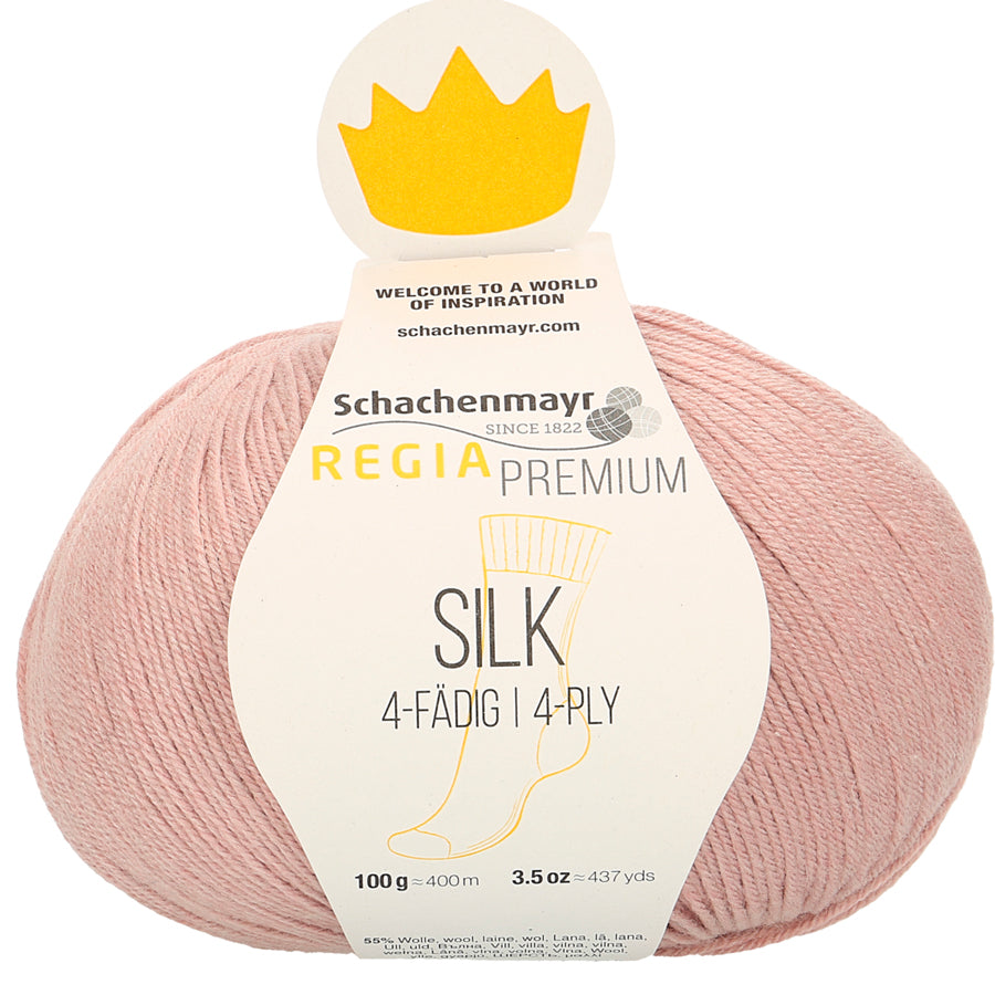 A skein of Schachenmayr Regia Premium Silk yarn in pink color, labeled as 4-ply with 100g/400m length.