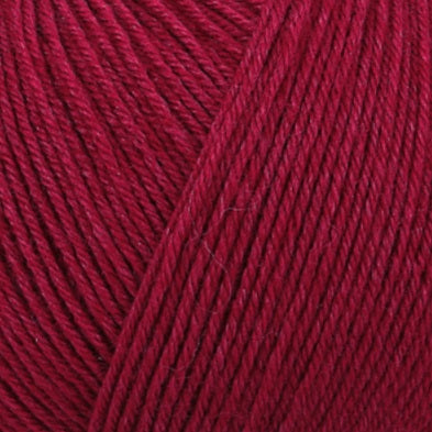 A skein of Schachenmayr Regia Premium Silk yarn in pink color, labeled as 4-ply with 100g/400m length in maroon red colour