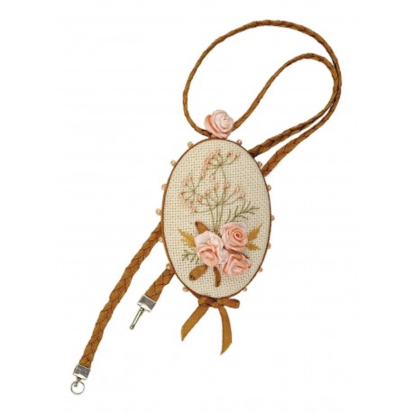 A cross-stitch embroidery pendant kit with a floral design, featuring a brown and white thread on a fabric background, and a brown ribbon for attachment.